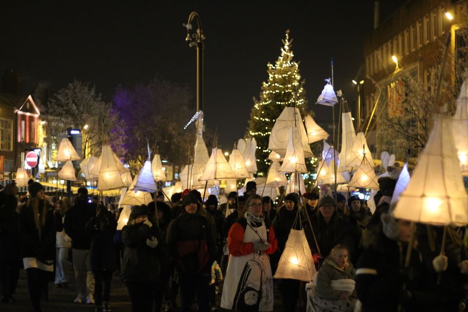 Illuminated lanterns being paraded through Newcastle Town Centre by lots of people